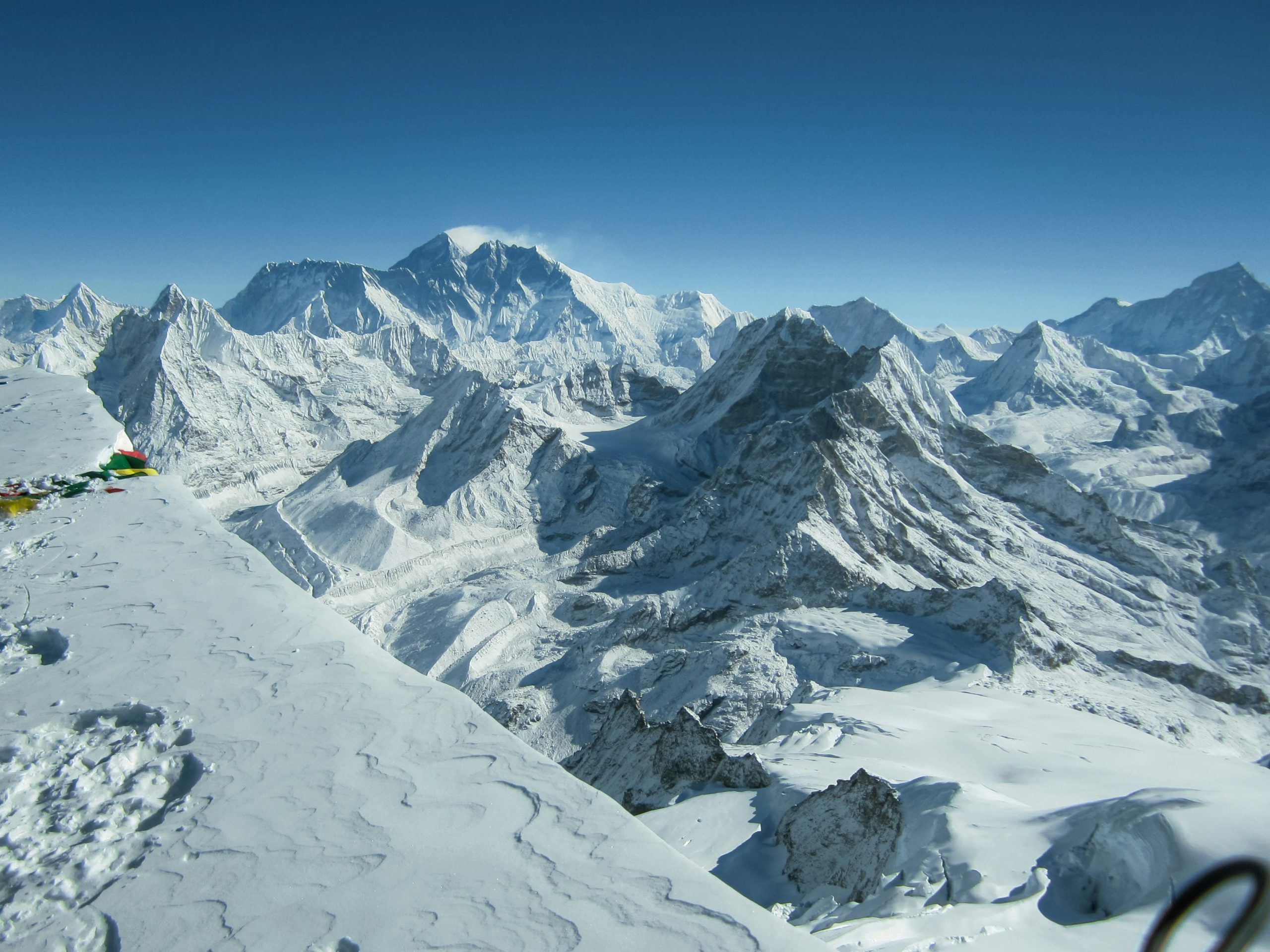 Prayer flags on a Khumbu summit, with Everest in the background, Nepal